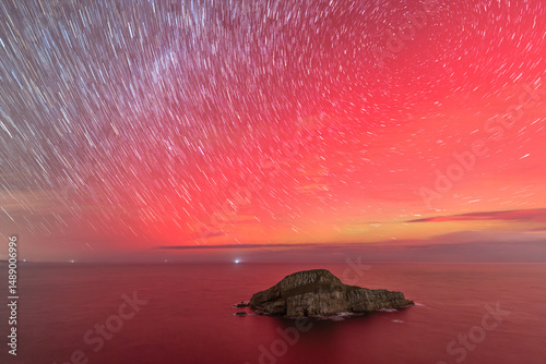 Circumpolar under the Northern Lights on the island of La Deva, Asturias, Spain