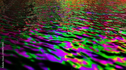 Abstract multicolored water ripples in vivid green, purple, red, and black creating a psychedelic pattern with a dark, iridescent tone.