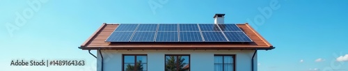 Modern house with solar panels on roof against clear blue sky, clean energy, electricity