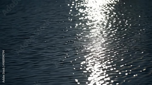 Sunlight reflected on the surface of water creating glittering patterns and shimmering light spots, creating mesmerizing visual textures.