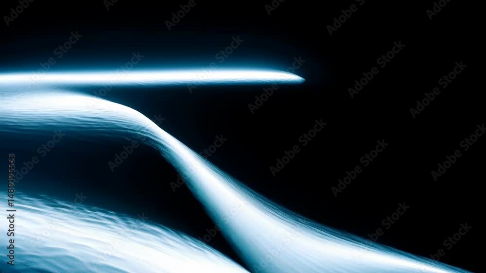 Abstract blue flowing wave shape in dark background, creating soft ethereal water like effects with long exposure technique.