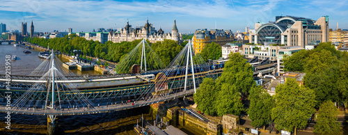 Aerial view of London Charing Cross railway station with its arched glass facade, train platforms, and surrounding city buildings