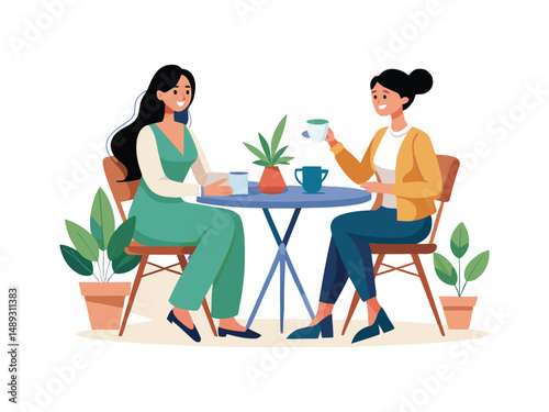 Two smiling women enjoying coffee together at a small table

