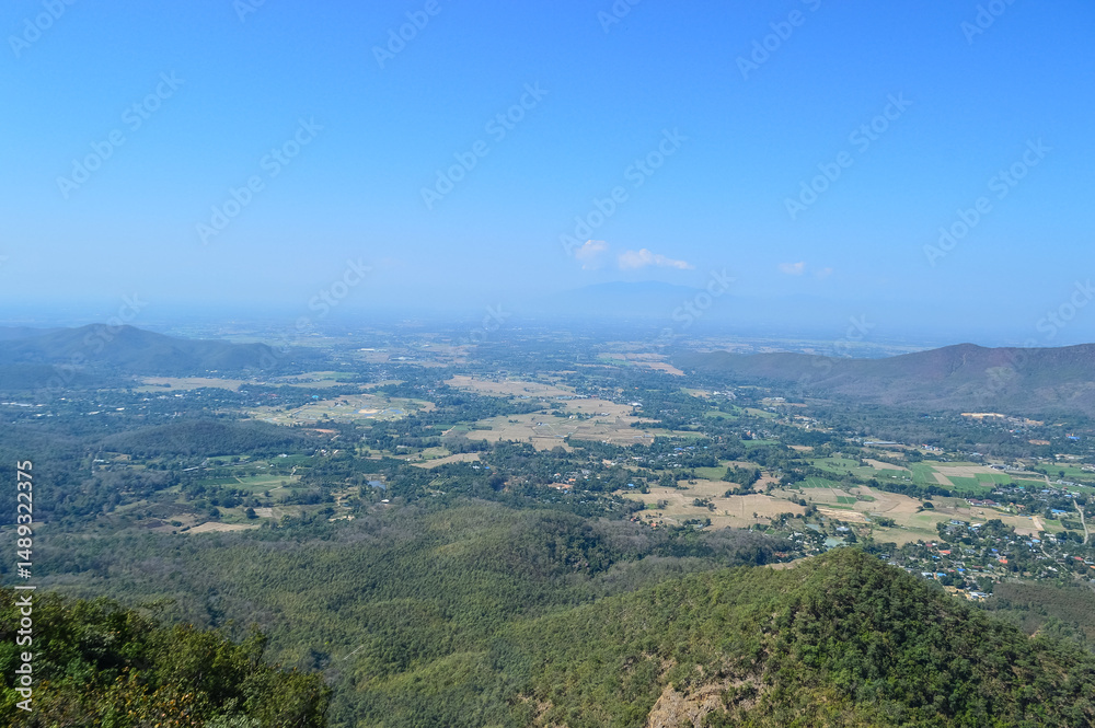 Obraz premium Distant Mountains and Forest with Trees and Sky in Northern Thailand.