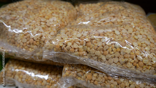 Close-up of many pea groats packages on a store shelf photo