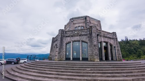 Drone footage shows the iconic Vista House observatory at Crown Point, offering expansive views of Columbia River Gorge's cliffs, forest, and winding river.