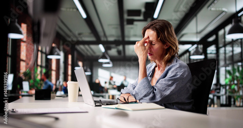 Stressed Accountant Works Overtime On Laptop With Headache