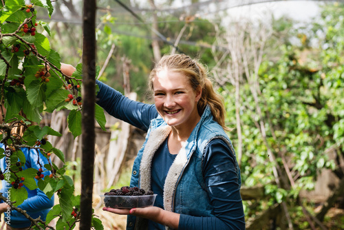 teen girl picking mulberries