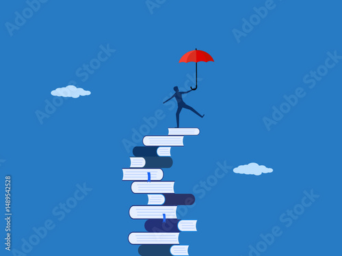 man balancing an umbrella on a pile of books that is about to fall