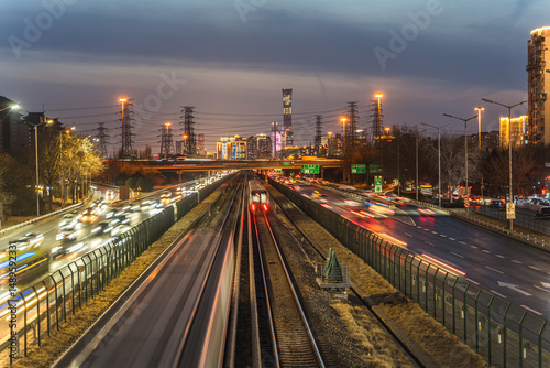 The urban evening rush hour of rail transit and vehicle flow at night in Beijing, China
