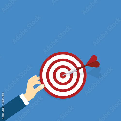 Hand holding a target, showing a goal. Red arrow hits the center. Business challenge failure and success concept