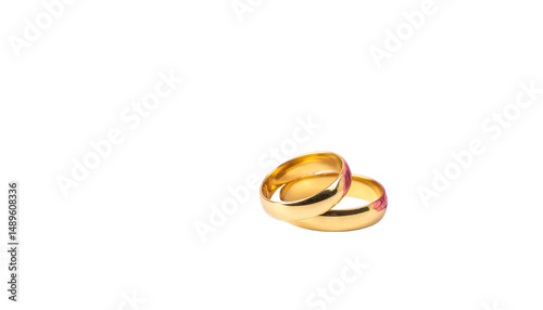 Two gold wedding rings are elegantly intertwined, symbolizing love and commitment. smooth, polished surface reflects light beautifully, creating sense of warmth and unity