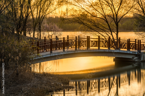 The wooden bridge by the lake at sunset