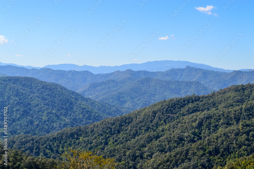 Fototapeta premium Distant Mountains and Forest with Trees and Sky in Northern Thailand.