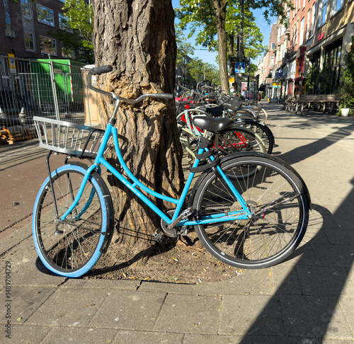 Obraz na płótnie Bicycles parked at the city center, narrow pedestrian street and buildings background. Netherlands w salonie