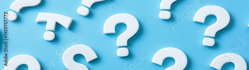 Many question marks on a light blue background