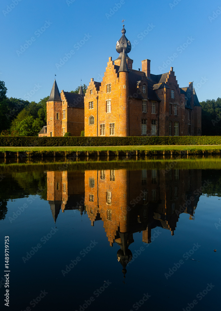 Obraz premium Reflection of Rumbeke Castle in water on summer day located in Rumbeke in West Flanders, Belgium