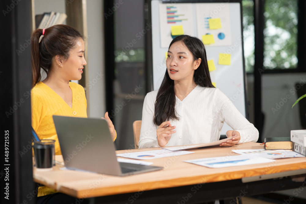 Businesswoman sitting in a meeting, talking about a document and chart placed on the table. Businesswoman sitting in a meeting, talking about a document and chart placed on the table.