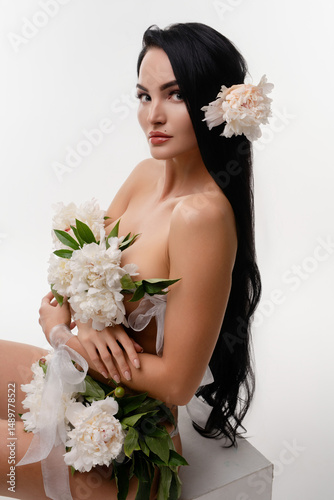 Brunette beauty adorned with flowers in a serene natural setting