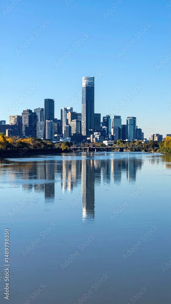 Obraz premium Tranquil City Skyline Reflected in Calm River Waters