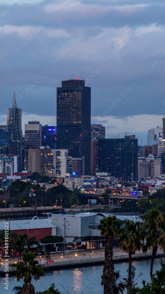 Fototapeta premium Urban City Skyline at Dusk with Emergency Lights Flashing Brightly