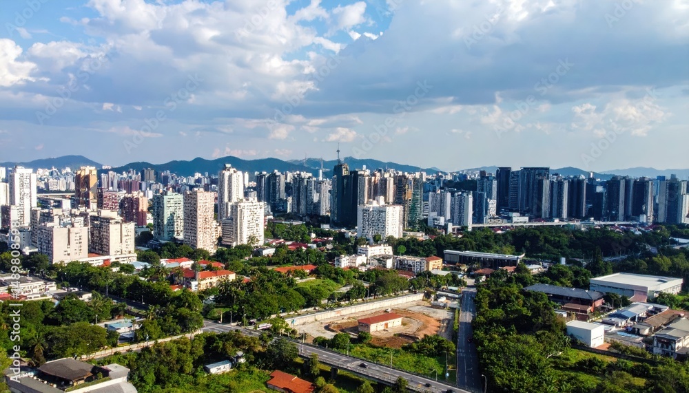 Obraz premium Aerial View of Urban Cityscape Under Dramatic Cloudy Sky