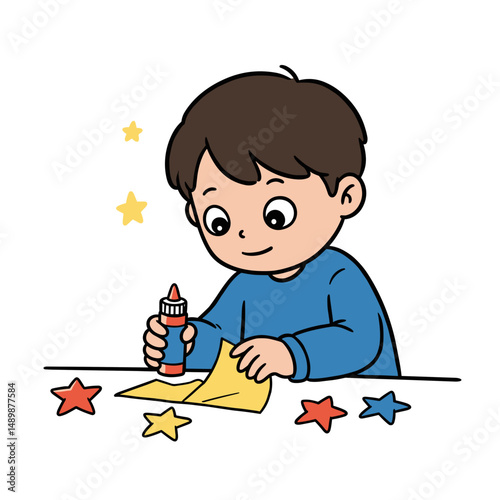 Happy boy crafting with glue and colored paper