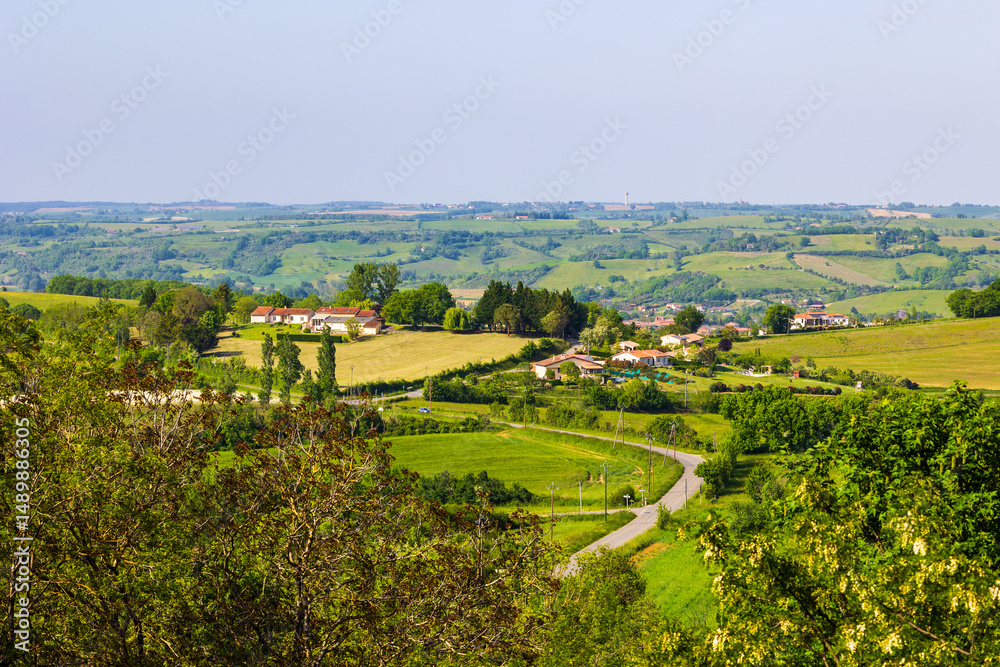Fototapeta premium Agricultural landscape of hills, hedges, and forests in the valley of the Lèze from the village of Carla-Bayle
