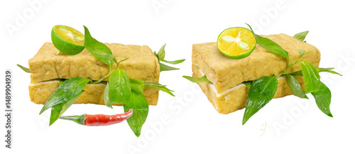 Golden-fried tofu slices stuffed with fresh Vietnamese mint, accompanied by a vibrant red chili pepper and a juicy calamansi  lime wedge, creating a visually appetizing dish.