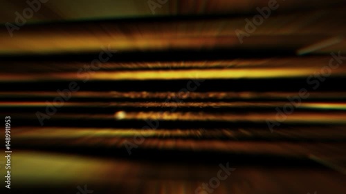 Abstract animation of glowing golden horizontal light streaks with sparkling particles. Fast motion blur effect on black background