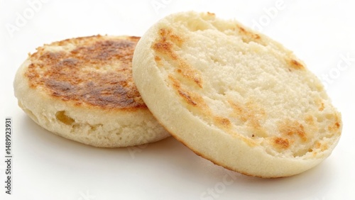 Two toasted English muffins stacked together on a white background.
