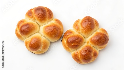 Two golden-brown baked rolls shaped like flowers on a white background.