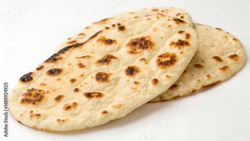 Freshly baked flatbreads with toasted spots on a light background.