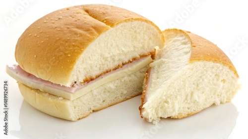 Freshly cut sandwich with ham and cheese on a soft bun, ready to be enjoyed.