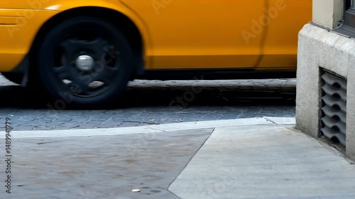 Yellow taxi cab side view motion blur on urban street