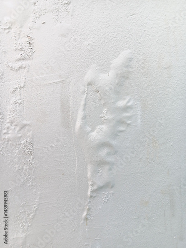 Abstract texture of blistering or bubbles paint on a white wall.