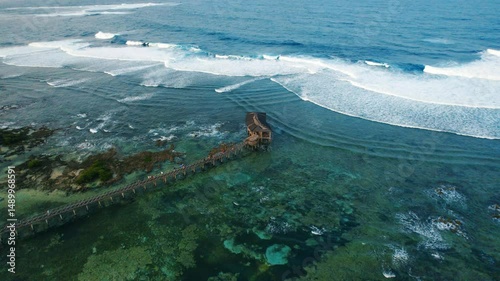drone view of a Boardwalk and Breaking Waves from above at Cloud 9 Surf Spot in Siargao, Philippines