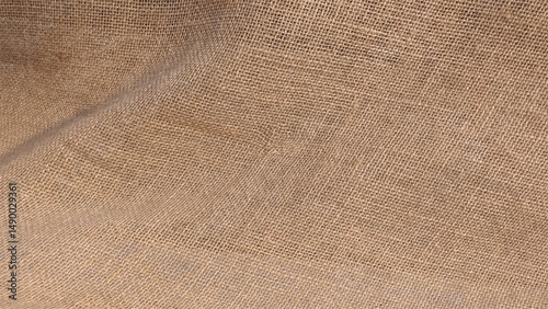 Jute pattern, rough burlap texture, canvas coarse cloth, brown woven rustic bagging. Hessian sackcloth woven fabric texture background in beige cream brown color