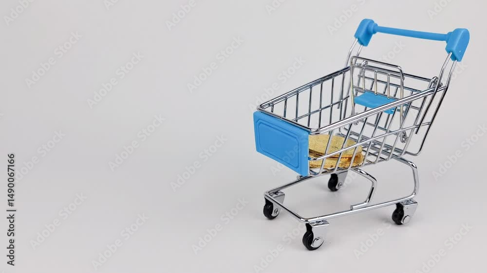 Many bitcoins dropped in into miniature shopping cart isolated - on white background.