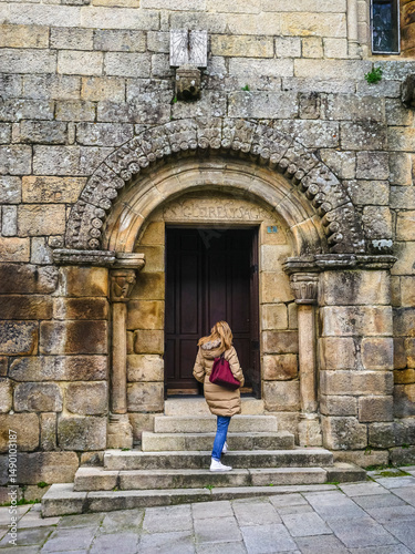 WOMAN IN THE ROMANESQUE CHURCH OF SANTIAGO IN ALLARIZ LOCATED IN THE OLD TOWN IN THE MAIN SQUARE