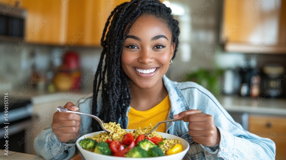Smiling woman enjoying a colorful and healthy salad in kitchen setting Smiling woman enjoying a colorful and healthy salad in kitchen setting