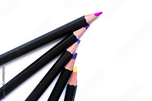 Close-up of colorful wooden pencils forming a semi-circle on a white background. Artistic pattern with vivid tips in soft focus, symbolizing creativity and color harmony.
