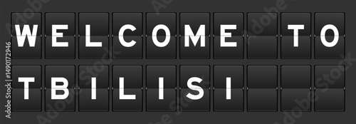 Black color analog flip board with word welcome to tbilisi on gray background