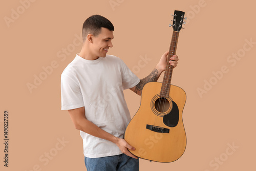 Young man with guitar on be...