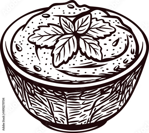 Wooden bowl of creamy dip with mint garnish in black and white