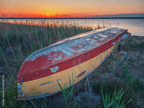 landscape with over off fishing boat in reeds with view to sunrise