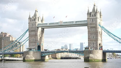 Still Shot of Tower Bridge with Double-Decker Buses and Cloudy Sky
