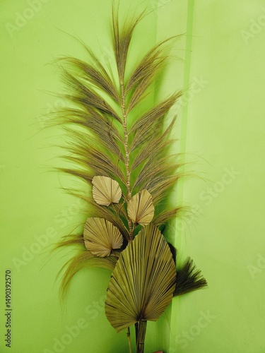 Dried plant arrangement against a vibrant backdrop.