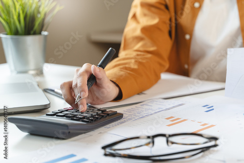 Wallpaper Mural person using calculator calculating tax refund on the table Torontodigital.ca