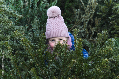 Child Peeking Through Christmas Trees